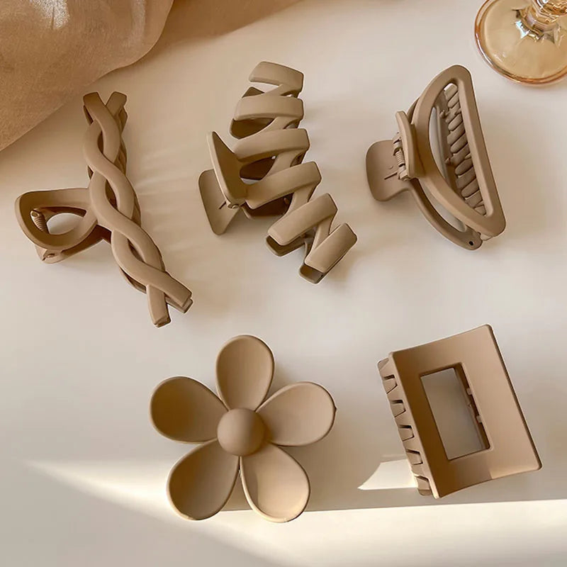 Collection of stylish brown hair claws in various shapes, perfect for elegant hairstyles and everyday use.